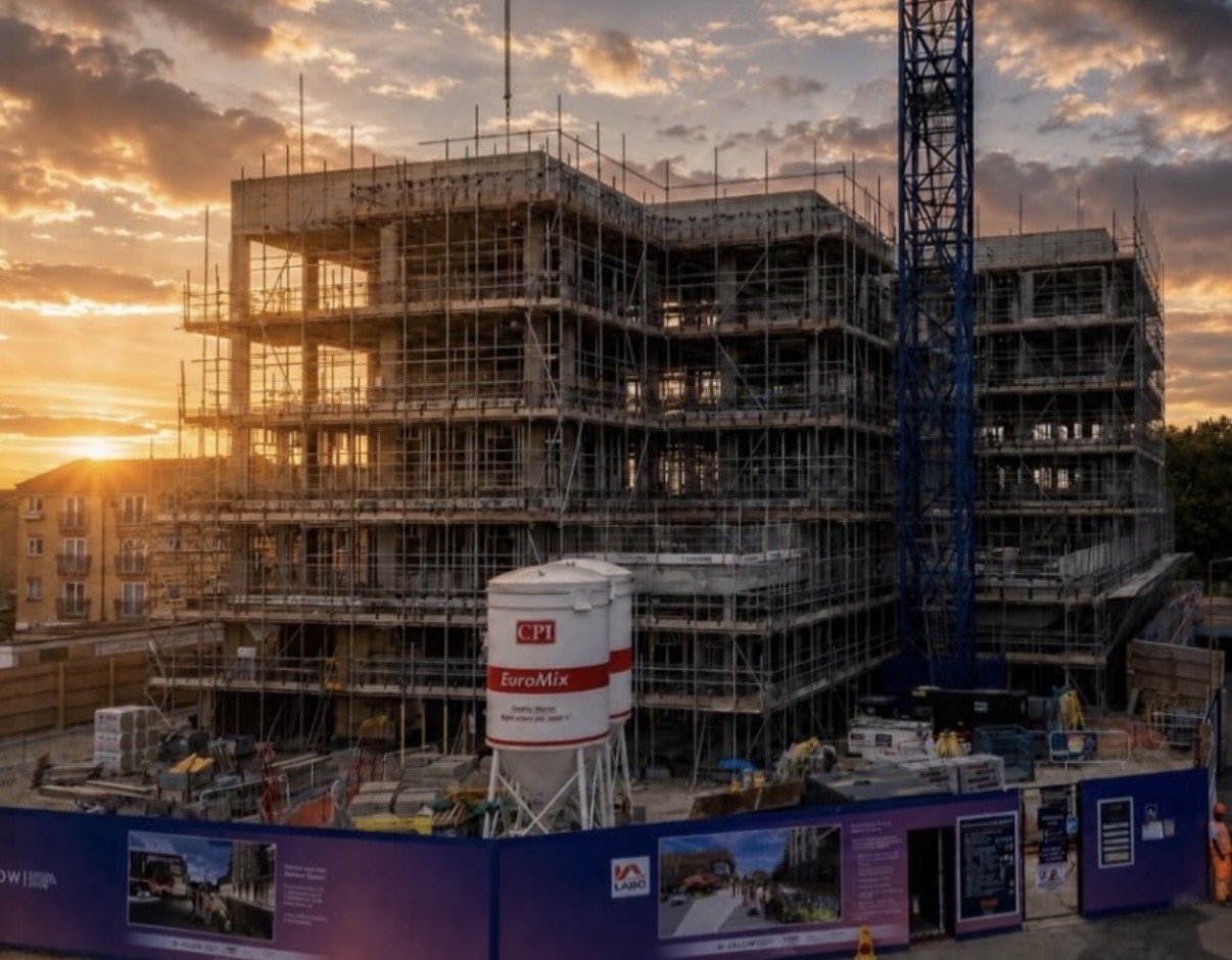 Scaffolding around a building under construction at sunset